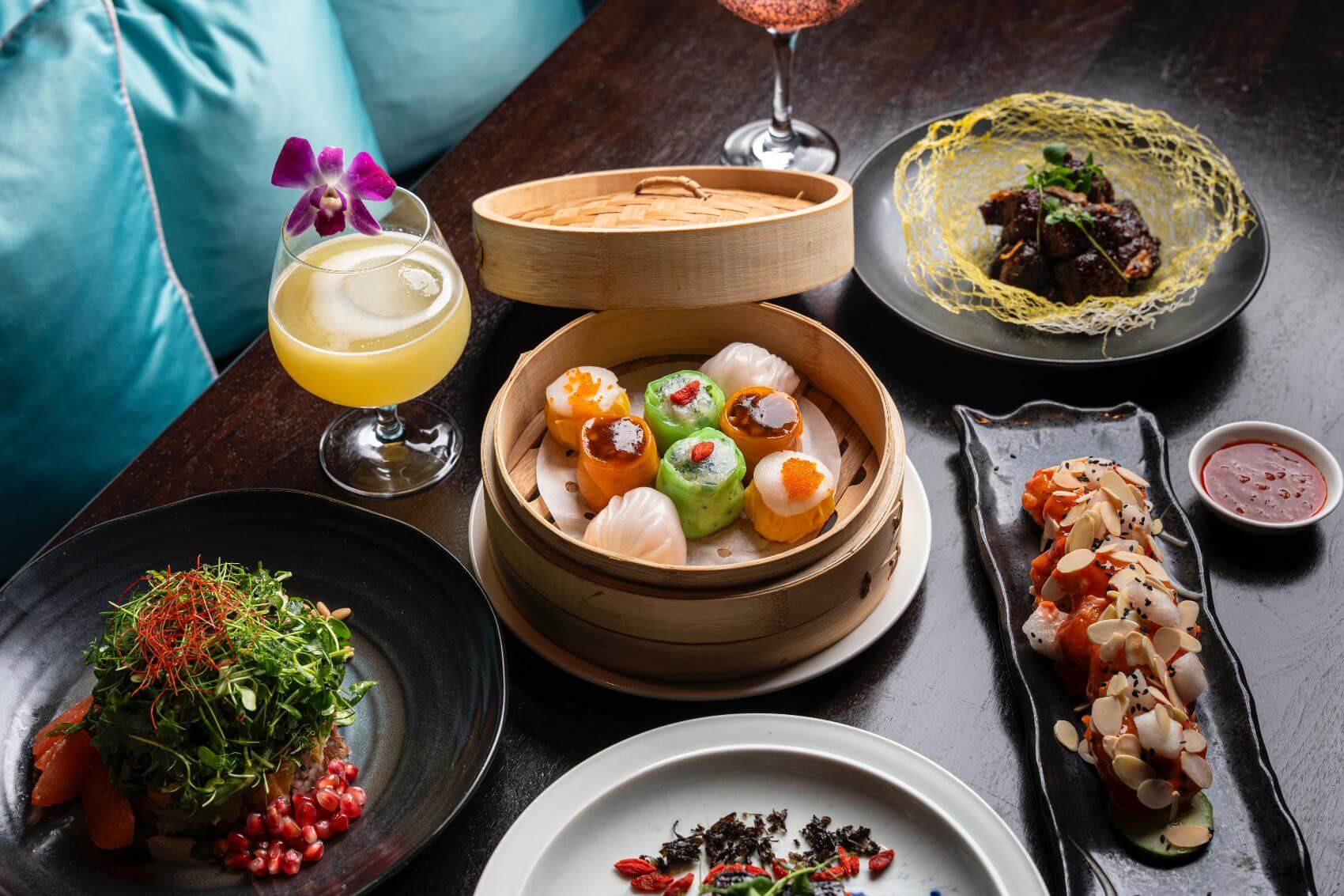 A table set with various Asian-inspired dishes and drinks